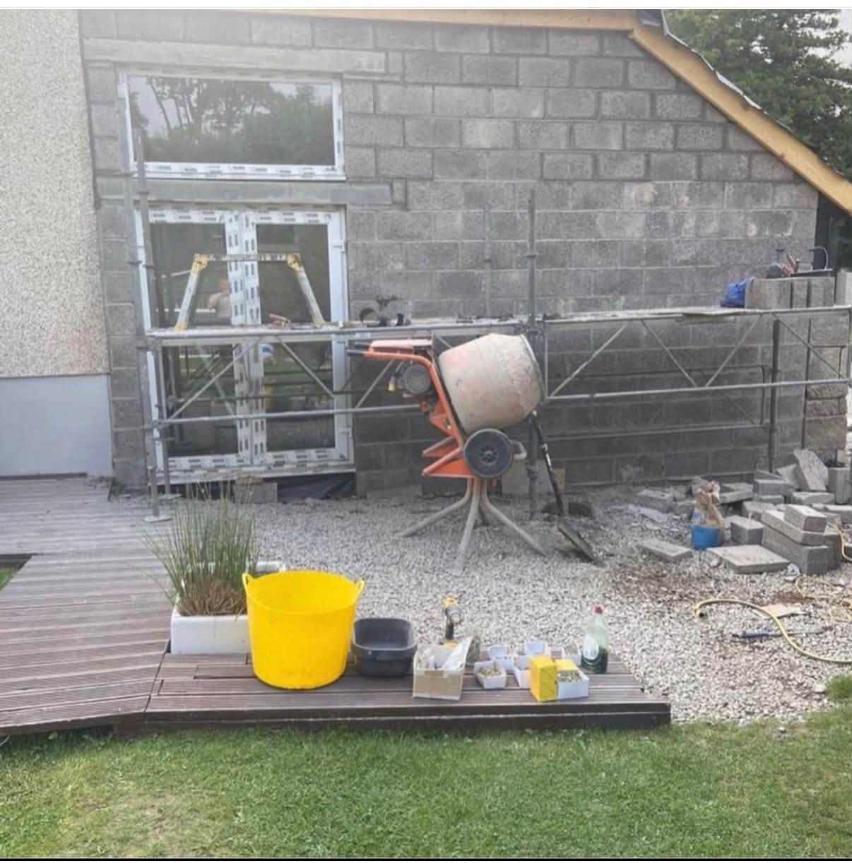 Blockwork rear of the Bonkle extension, with patio doors and a cement mixer